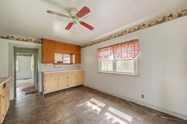 kitchen featuring light countertops and a ceiling fan