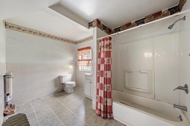 full bathroom with tile walls, toilet, shower / tub combo, a wainscoted wall, and vanity