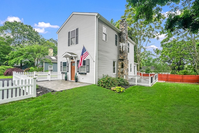 1755 Parmly Rd, Mohegan Lake, NY 10547 - view of front of house featuring a patio area, a chimney, and a fenced backyard