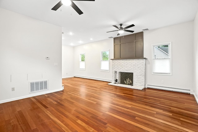 1755 Parmly Rd, Mohegan Lake, NY 10547 - unfurnished living room with a baseboard heating unit, a ceiling fan, wood finished floors, and recessed lighting