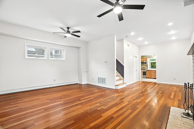 1755 Parmly Rd, Mohegan Lake, NY 10547 - unfurnished living room with ceiling fan, stairway, wood finished floors, a baseboard heating unit, and recessed lighting