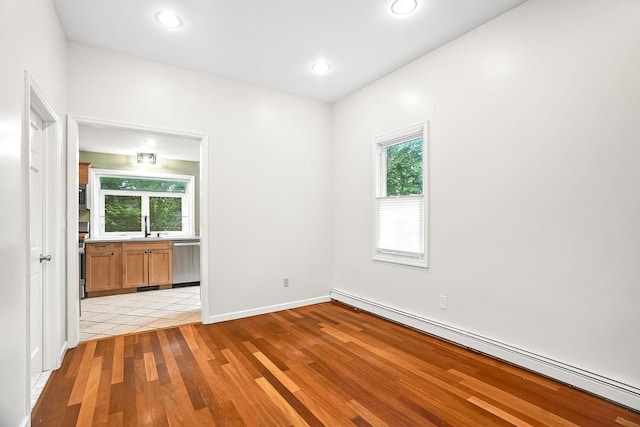 1755 Parmly Rd, Mohegan Lake, NY 10547 - empty room with baseboard heating, healthy amount of natural light, light wood-style flooring, and recessed lighting