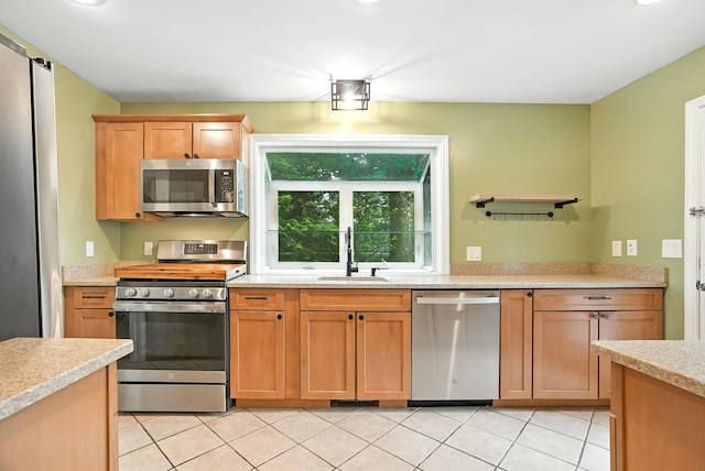1755 Parmly Rd, Mohegan Lake, NY 10547 - kitchen with stainless steel appliances, light countertops, and light tile patterned floors