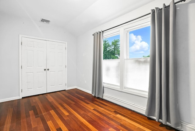 1755 Parmly Rd, Mohegan Lake, NY 10547 - unfurnished bedroom with vaulted ceiling, dark wood finished floors, and a closet