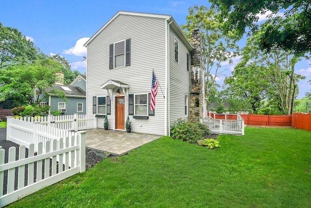 1755 Parmly Rd, Mohegan Lake, NY 10547 - view of front of property featuring a patio area, a chimney, and a fenced backyard