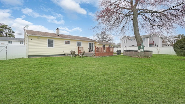 rear view of house with a wooden deck and a chimney