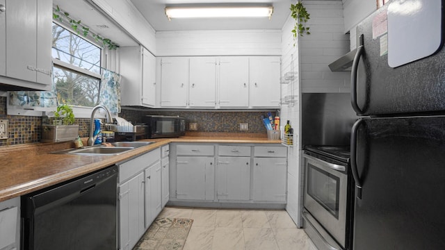 kitchen featuring black appliances, a sink, light marble finish flooring, white cabinetry, and tasteful backsplash