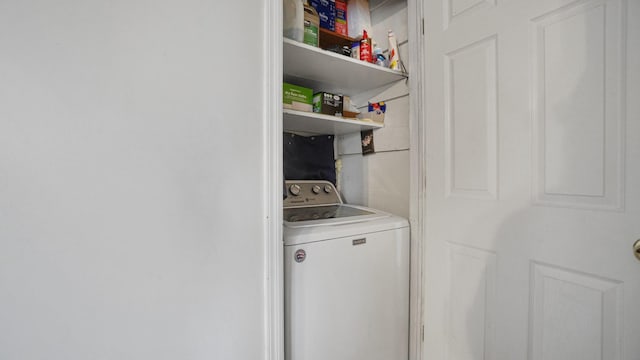 clothes washing area with washer / dryer