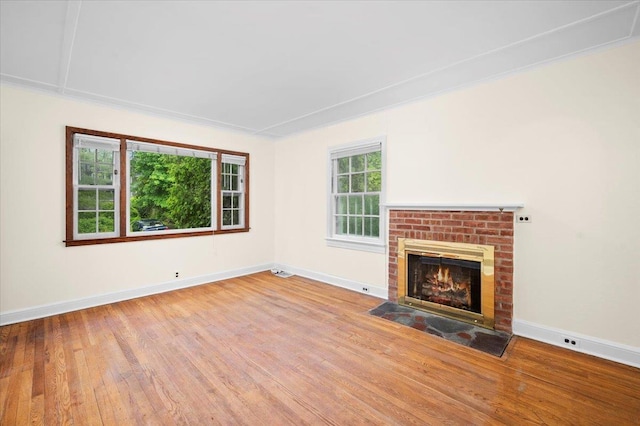 2 Ashley Rd, Hastings-On-Hudson, NY 10706 - unfurnished living room with wood finished floors, baseboards, and a brick fireplace