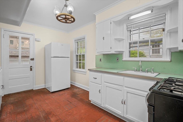2 Ashley Rd, Hastings-On-Hudson, NY 10706 - kitchen with freestanding refrigerator, a sink, black range with gas cooktop, a chandelier, and brick patterned floors