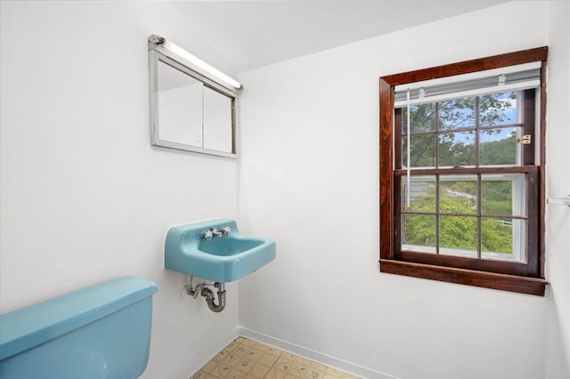 2 Ashley Rd, Hastings-On-Hudson, NY 10706 - half bathroom with baseboards, tile patterned floors, a sink, and toilet