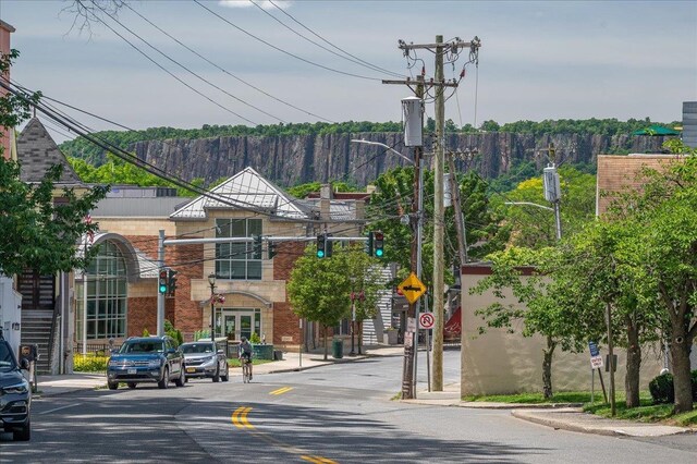 2 Ashley Rd, Hastings-On-Hudson, NY 10706 - view of asphalt road with traffic signs, sidewalks, curbs, and street lights