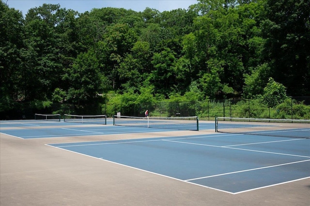 2 Ashley Rd, Hastings-On-Hudson, NY 10706 - view of tennis court featuring community basketball court, fence, and a forest view