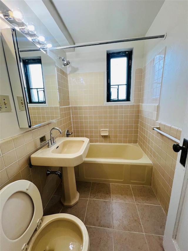 1560 Metropolitan Ave, Bronx, NY 10462 - bathroom featuring tile walls, plenty of natural light, shower / bathtub combination, and toilet