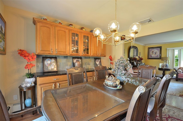 1793 Brian Ct, South Merrick, NY 11566 - dining area with a chandelier, wood finished floors, ornamental molding, and baseboard heating