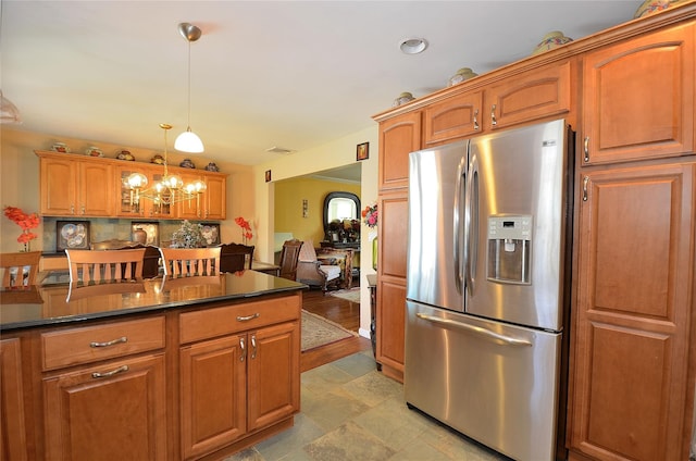 1793 Brian Ct, South Merrick, NY 11566 - kitchen with stainless steel fridge with ice dispenser, dark countertops, brown cabinets, decorative light fixtures, and backsplash
