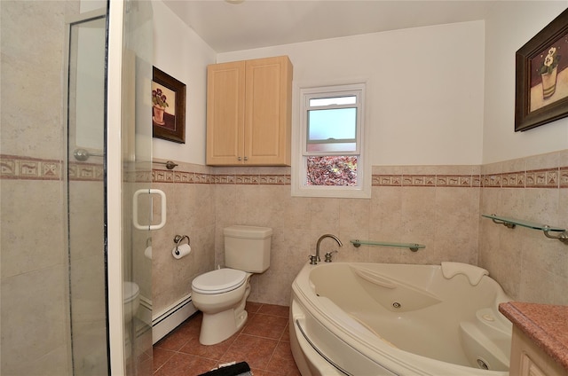 1793 Brian Ct, South Merrick, NY 11566 - bathroom featuring baseboard heating, toilet, tile walls, tile patterned flooring, and a whirlpool tub