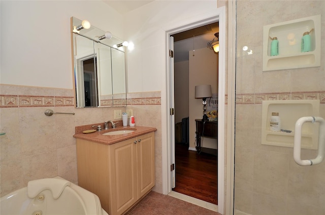 1793 Brian Ct, South Merrick, NY 11566 - full bath with tile walls, a jetted tub, vanity, and tile patterned floors