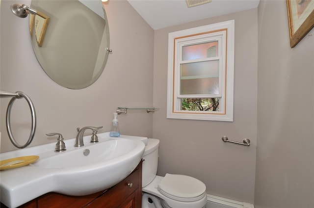 1793 Brian Ct, South Merrick, NY 11566 - half bathroom with toilet, vanity, and baseboard heating