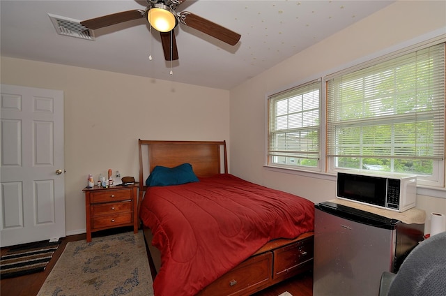 1793 Brian Ct, South Merrick, NY 11566 - bedroom featuring fridge, wood finished floors, and ceiling fan