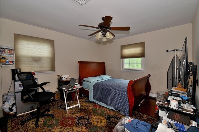 1793 Brian Ct, South Merrick, NY 11566 - bedroom with baseboard heating and a ceiling fan