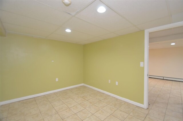 1793 Brian Ct, South Merrick, NY 11566 - empty room with baseboard heating, recessed lighting, a paneled ceiling, baseboards, and light tile patterned floors