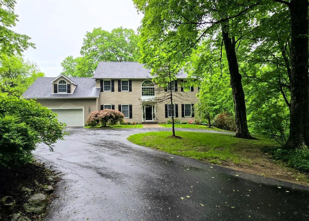 148 Couch Rd, Patterson, NY 12563 - colonial home featuring asphalt driveway, a garage, and a front lawn