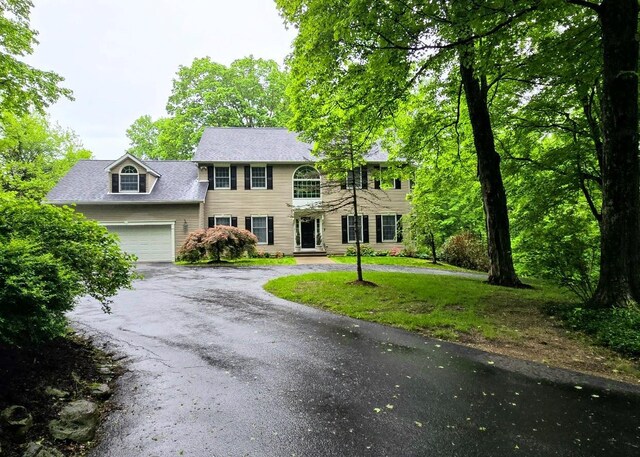 148 Couch Rd, Patterson, NY 12563 - colonial home featuring asphalt driveway, a garage, and a front lawn