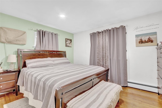 220 Boundary Ave, Massapequa, NY 11758 - bedroom with a baseboard heating unit, wood finished floors, and recessed lighting