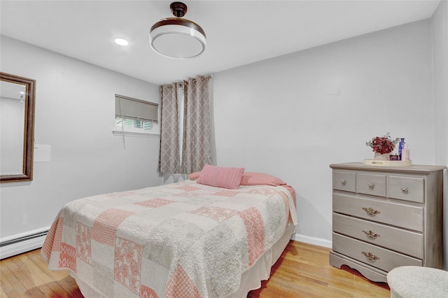 220 Boundary Ave, Massapequa, NY 11758 - bedroom featuring light wood-style floors, a baseboard heating unit, recessed lighting, and baseboards
