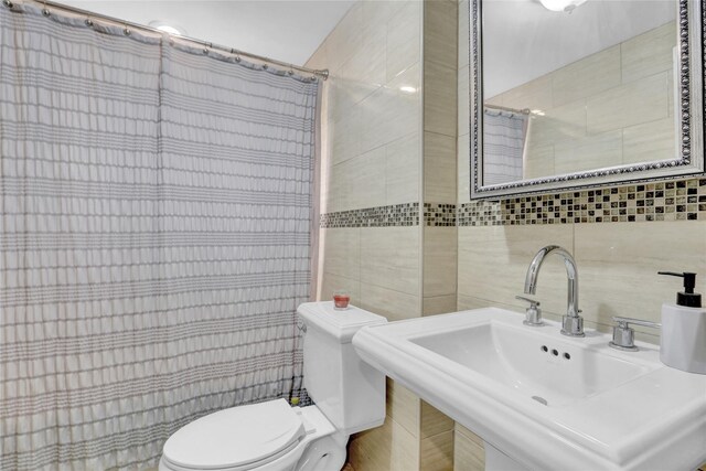 220 Boundary Ave, Massapequa, NY 11758 - bathroom with tile walls, toilet, a sink, and a shower with shower curtain
