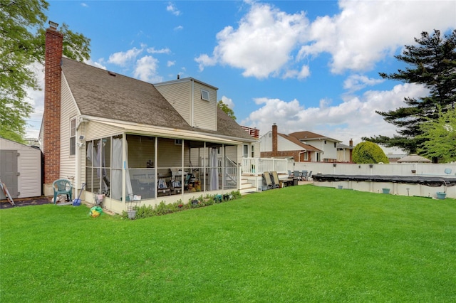 220 Boundary Ave, Massapequa, NY 11758 - back of property with a sunroom, a storage shed, a lawn, and an outbuilding