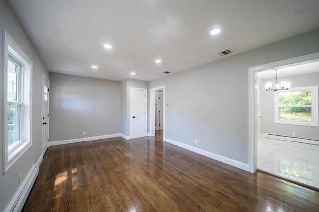 23 Wheat Path Rd W, Mount Sinai, NY 11766 - empty room with a baseboard radiator, a baseboard heating unit, a chandelier, dark wood-style flooring, and recessed lighting