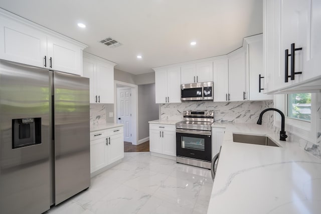 23 Wheat Path Rd W, Mount Sinai, NY 11766 - kitchen featuring appliances with stainless steel finishes, a sink, light stone counters, recessed lighting, and white cabinets
