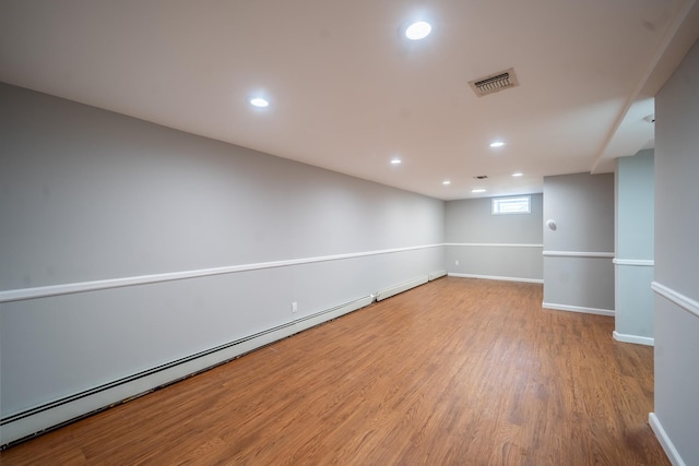 23 Wheat Path Rd W, Mount Sinai, NY 11766 - basement featuring baseboard heating, wood finished floors, recessed lighting, and baseboards