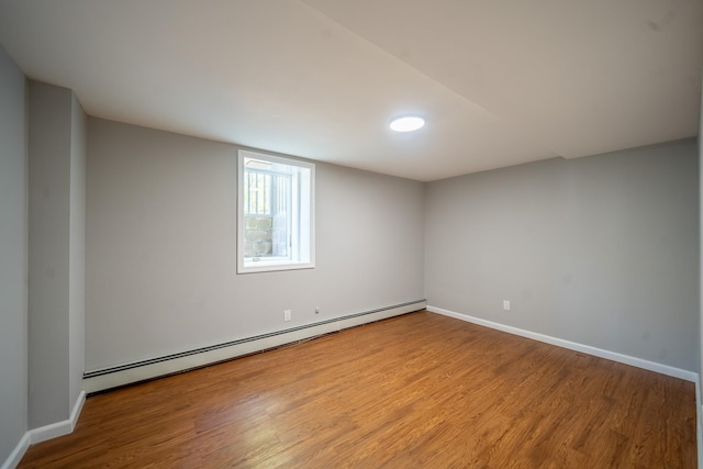 23 Wheat Path Rd W, Mount Sinai, NY 11766 - unfurnished room with a baseboard radiator, wood finished floors, and baseboards