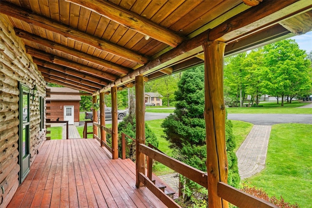 wooden terrace with a yard and a porch