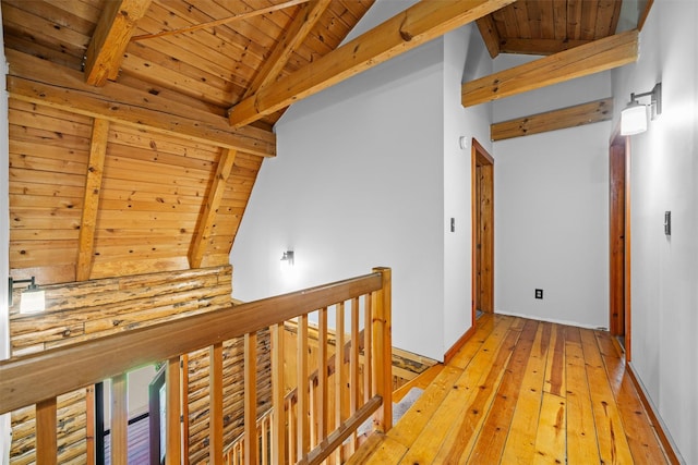 hallway featuring wood ceiling, light wood-type flooring, and an upstairs landing