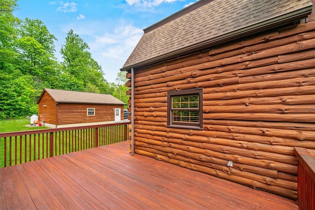 wooden deck with an outbuilding and a yard
