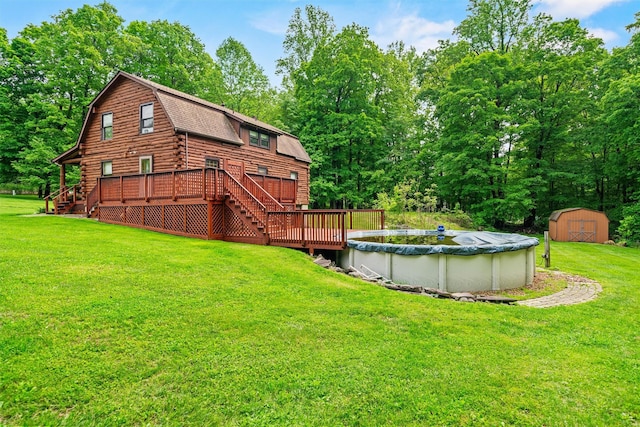 view of grassy yard with a wooden deck, a storage unit, stairs, and an outbuilding