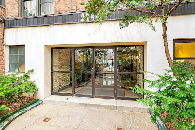 2244 Bronx Park E Unit 2E, Bronx, NY 10467 - view of exterior entry featuring brick siding and french doors
