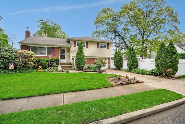 1243 Sylvia Ave, Baldwin, NY 11510 - split level home featuring brick siding, driveway, a garage, and a chimney