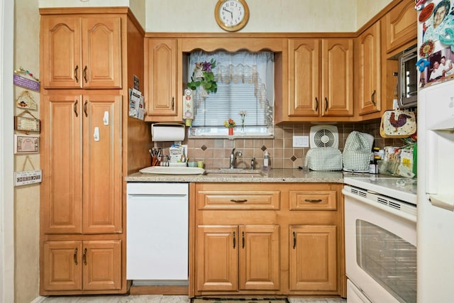 1243 Sylvia Ave, Baldwin, NY 11510 - kitchen featuring white appliances, a sink, decorative backsplash, light stone countertops, and brown cabinetry
