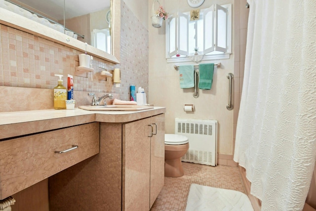 1243 Sylvia Ave, Baldwin, NY 11510 - bathroom with radiator heating unit, toilet, vanity, tasteful backsplash, and curtained shower
