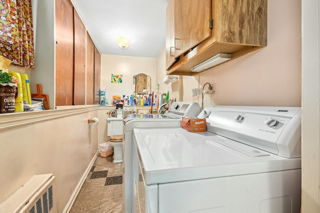 1243 Sylvia Ave, Baldwin, NY 11510 - laundry area with washing machine and dryer, cabinet space, light flooring, and baseboards