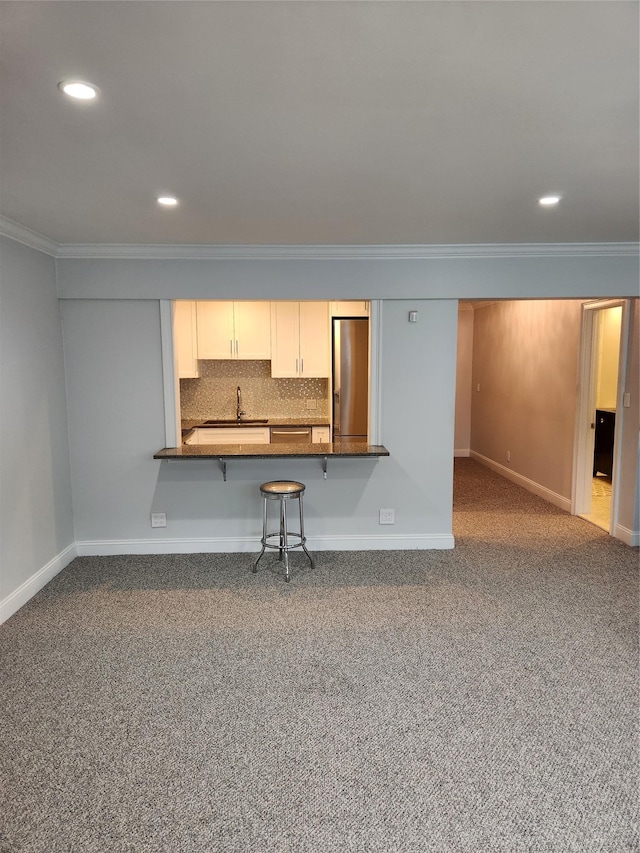1 Bengeyfield Dr Unit 2G, East Williston, NY 11596 - kitchen featuring stainless steel fridge, dark countertops, ornamental molding, baseboards, and dark colored carpet