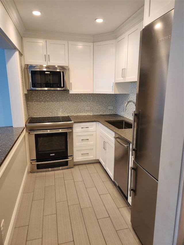 1 Bengeyfield Dr Unit 2G, East Williston, NY 11596 - kitchen featuring stainless steel appliances, a sink, white cabinetry, tasteful backsplash, and recessed lighting