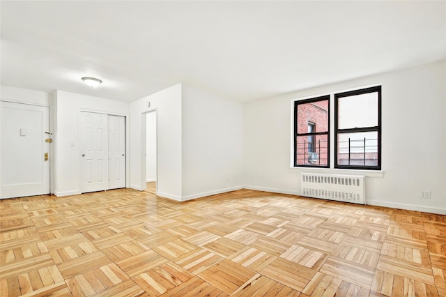 2244 Bronx Park E Unit 1E, Bronx, NY 10467 - empty room featuring radiator heating unit and baseboards