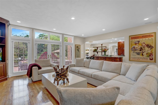 living area featuring light wood-type flooring and recessed lighting
