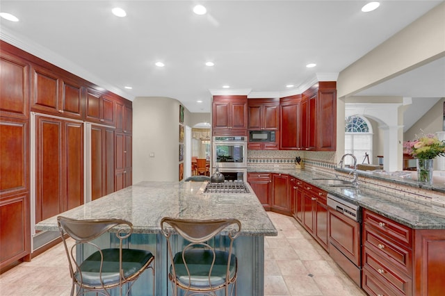 kitchen with a sink, black microwave, paneled dishwasher, dark brown cabinets, and double oven